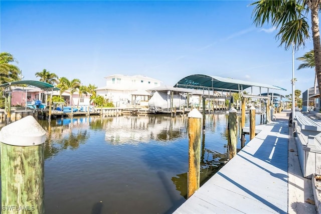 16221 Buccaneer St, Bokeelia, FL 33922 - view of dock featuring a water view, boat lift, and a residential view