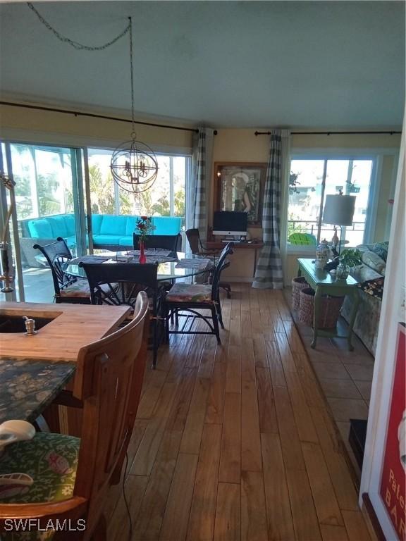 dining room with a chandelier and wood finished floors