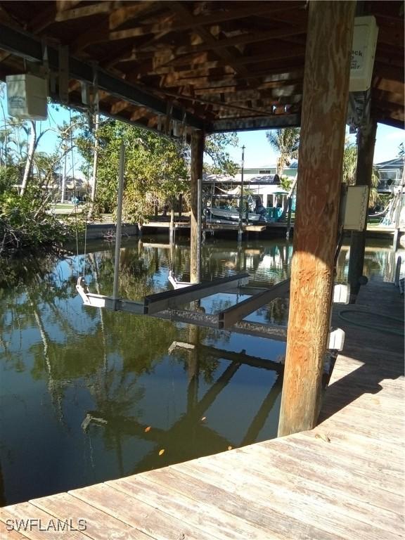 dock area with a water view and boat lift