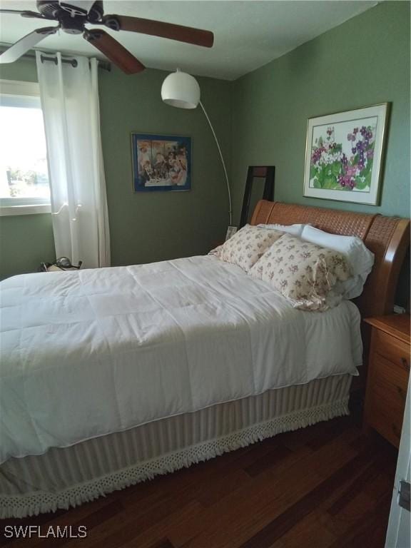 bedroom with vaulted ceiling, ceiling fan, and wood finished floors