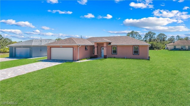 ranch-style home featuring a garage, stucco siding, decorative driveway, and a front lawn