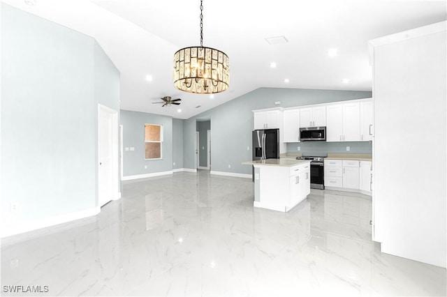 kitchen featuring stainless steel appliances, hanging light fixtures, light countertops, white cabinets, and a center island