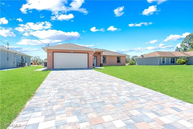 view of front of house featuring central air condition unit, a front yard, stucco siding, decorative driveway, and an attached garage