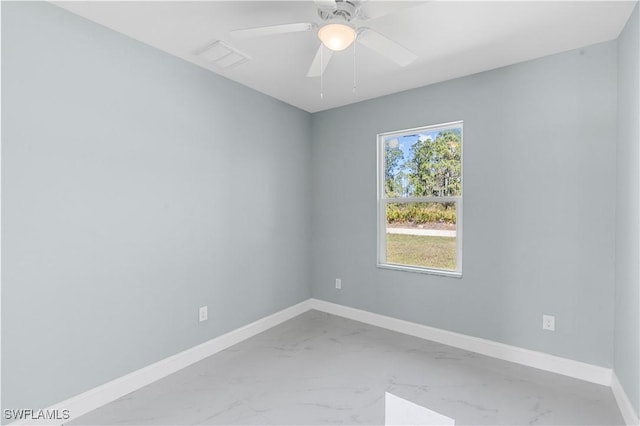 spare room with visible vents, marble finish floor, and baseboards