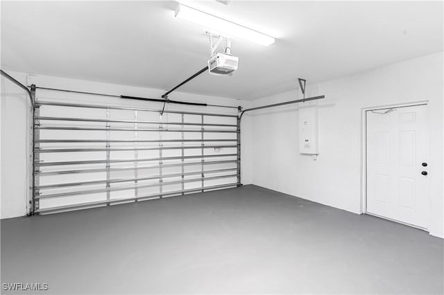 garage with electric panel and a garage door opener