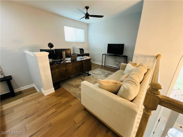 home office with light wood-type flooring, baseboards, and a ceiling fan