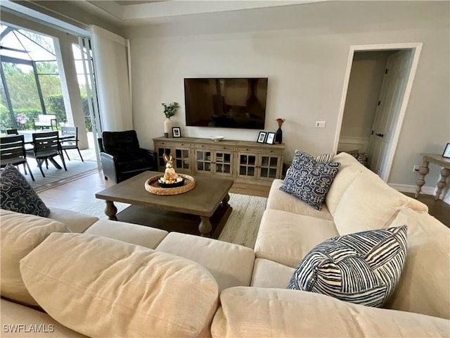 living area featuring light wood-style flooring and baseboards