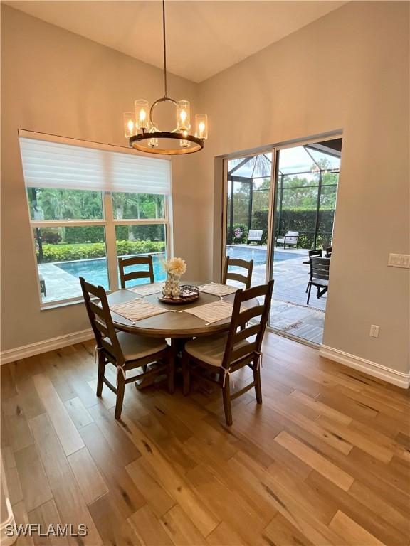 dining room featuring light wood finished floors, baseboards, and a wealth of natural light