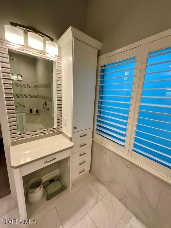 bathroom with marble finish floor