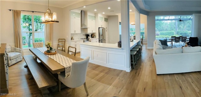 kitchen with light countertops, glass insert cabinets, appliances with stainless steel finishes, open floor plan, and white cabinets