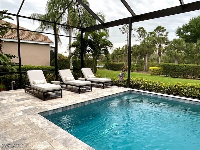 outdoor pool featuring a patio area and a lanai