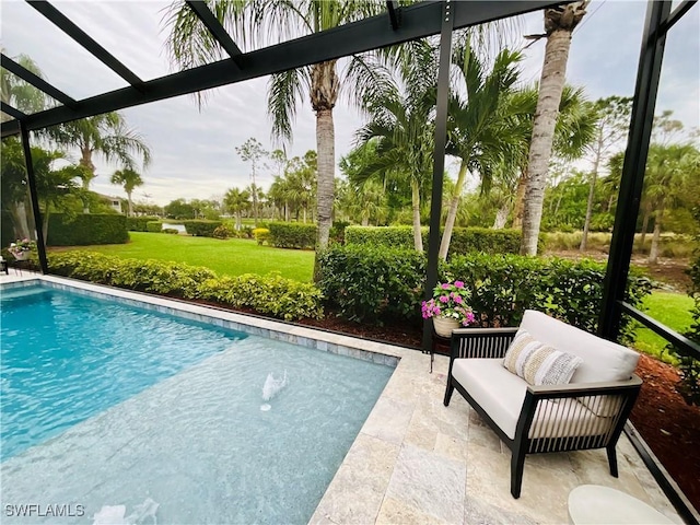 outdoor pool featuring glass enclosure, a yard, and a patio