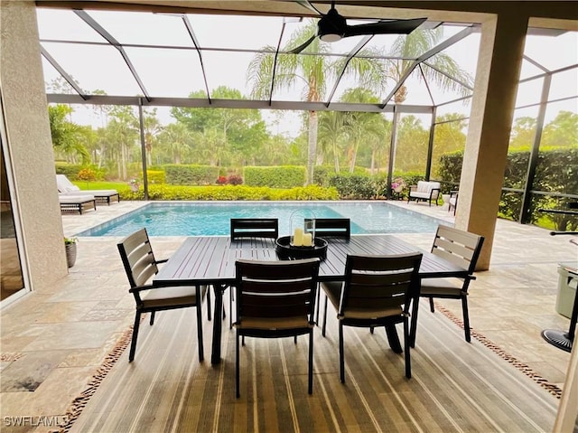 view of patio featuring outdoor dining space, a lanai, and an outdoor pool