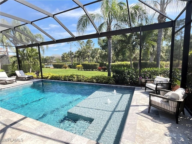 pool featuring a yard, a patio area, and a lanai