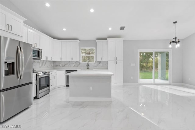 kitchen with visible vents, marble finish floor, light countertops, appliances with stainless steel finishes, and decorative backsplash