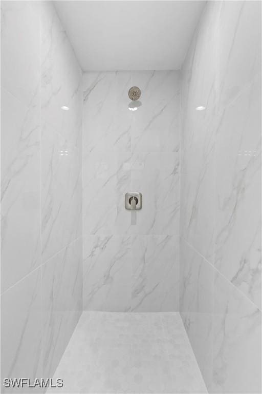 bathroom with a marble finish shower