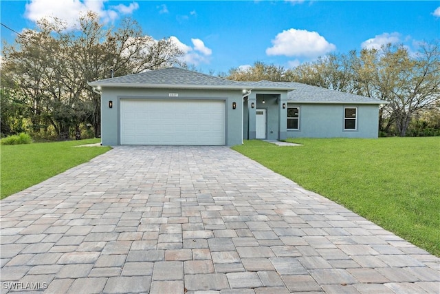 ranch-style home featuring a garage, a front yard, decorative driveway, and stucco siding