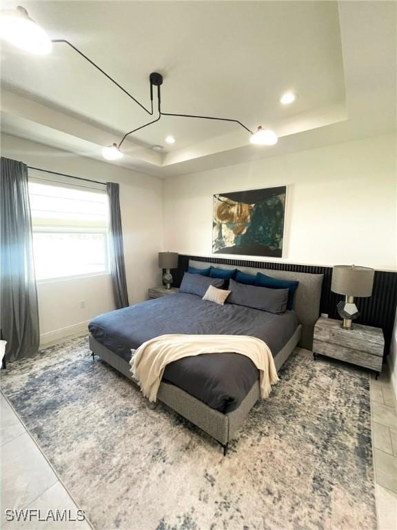 bedroom featuring a tray ceiling, baseboards, and recessed lighting