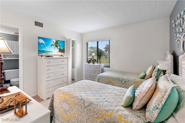 carpeted bedroom featuring visible vents and baseboards