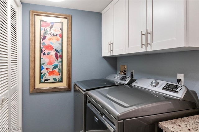 laundry area with cabinet space and washer and clothes dryer