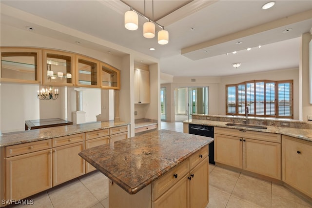 kitchen with a peninsula, black dishwasher, light brown cabinets, and a sink