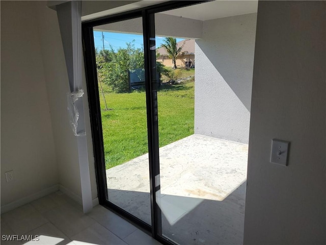 doorway to outside featuring light tile patterned floors and baseboards