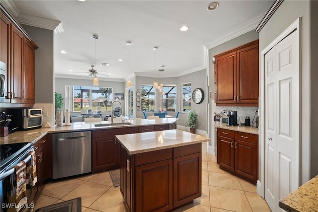 kitchen with a kitchen island, a peninsula, stainless steel dishwasher, pendant lighting, and a sink