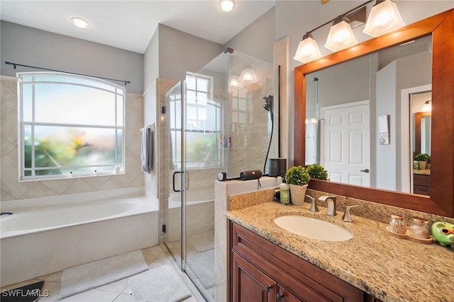 bathroom with a garden tub, tile patterned flooring, a shower stall, and vanity