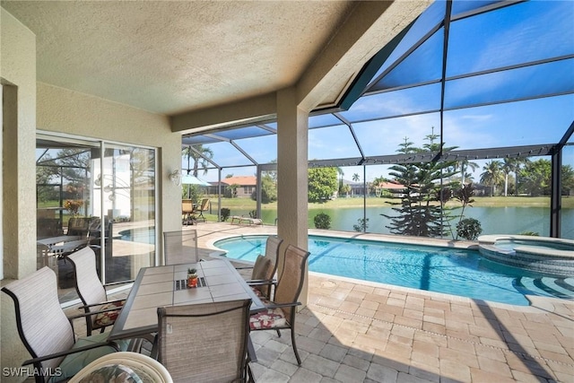 sunroom featuring a water view and a pool