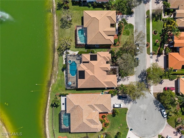 drone / aerial view featuring a residential view and a water view