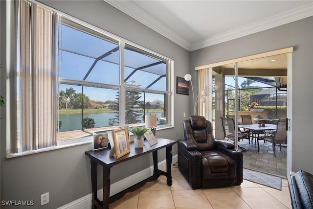 sitting room with a sunroom, a water view, crown molding, and baseboards