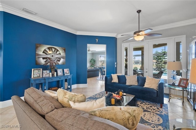 living room featuring light tile patterned floors, baseboards, visible vents, and crown molding