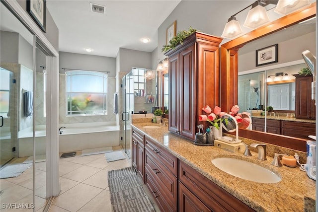 bathroom featuring visible vents, a sink, a shower stall, and a bath