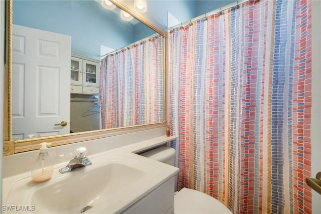 full bathroom with toilet and vanity