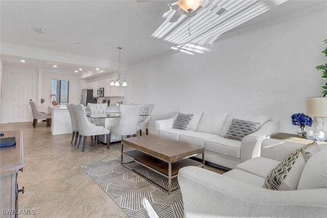 living area with ceiling fan with notable chandelier and recessed lighting