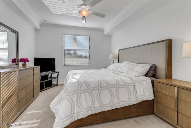 bedroom featuring ornamental molding, a ceiling fan, and light colored carpet