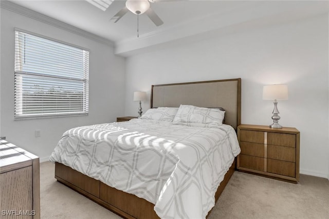 carpeted bedroom with ceiling fan, baseboards, and crown molding