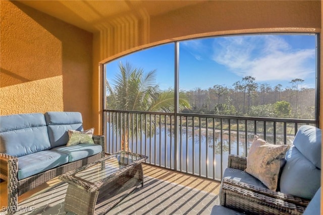 sunroom / solarium with a water view