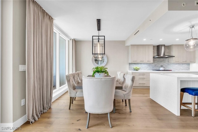 dining area with visible vents, baseboards, and light wood-style floors