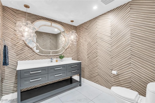 bathroom with visible vents, toilet, and vanity