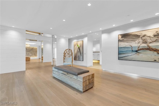 hall with recessed lighting, light wood-type flooring, and baseboards