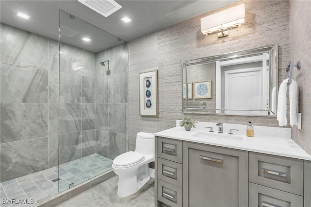 full bath featuring vanity, toilet, visible vents, and a stall shower