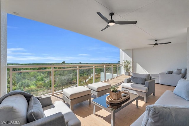 balcony with an outdoor living space and a ceiling fan