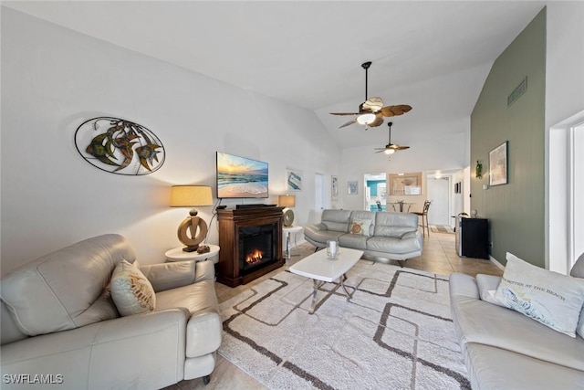 402 SE 42nd Ter Unit D-7, Cape Coral, FL 33904 - tiled living room featuring a warm lit fireplace, a ceiling fan, lofted ceiling, and visible vents
