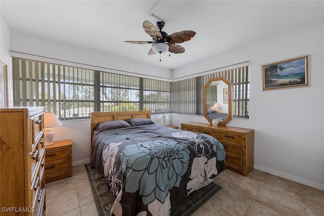 402 SE 42nd Ter Unit D-7, Cape Coral, FL 33904 - bedroom with baseboards, ceiling fan, and light tile patterned floors
