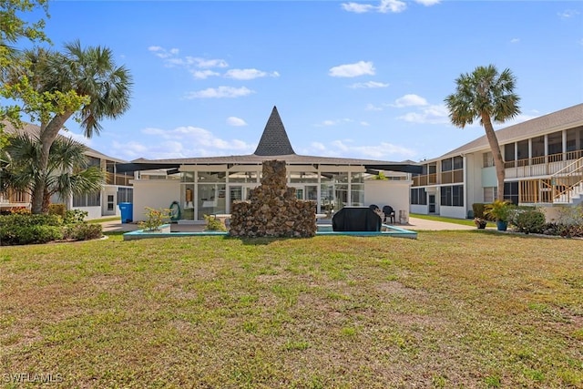 402 SE 42nd Ter Unit D-7, Cape Coral, FL 33904 - back of house with a patio area and a yard