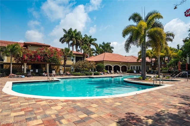 community pool featuring a patio area