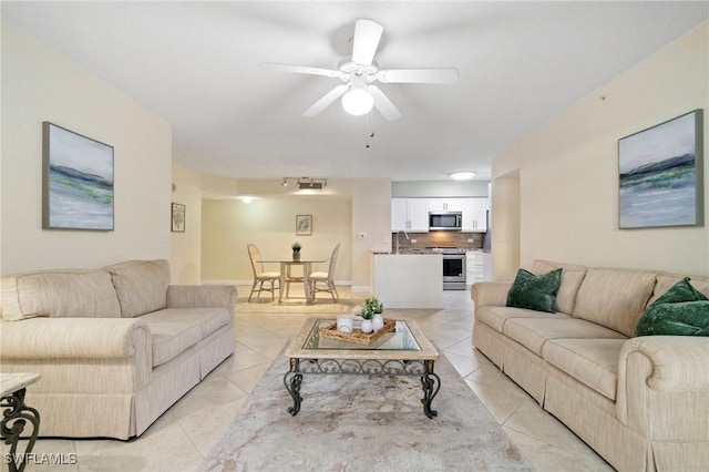 living area featuring light tile patterned floors and ceiling fan