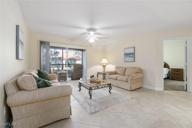 living room featuring ceiling fan, baseboards, and light tile patterned flooring