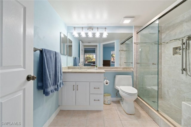 full bathroom featuring toilet, a shower stall, vanity, tile patterned flooring, and baseboards